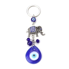 Detail of silver elephant keychain with blue evil eye glass charm and beads