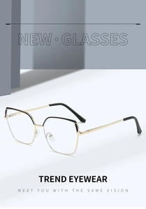Detail of metal square eyeglass frames with gold finish and black cat-eye brow accents