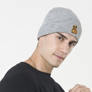 Men's light grey knit beanie with monkey embroidery patch shown on model