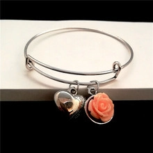 Detail view of silver adjustable bracelet with 3D heart and pink rose relief charms