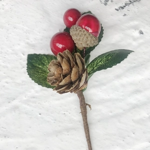 Artificial Christmas pine branch with red berries and brown cones for holiday DIY decor