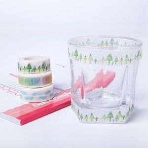 Three rolls of decorative forest and watercolor washi tape for DIY scrapbooking decor