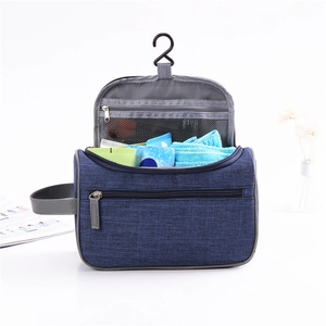 Waterproof hanging toiletry bag in navy blue with compartments and hook for travel