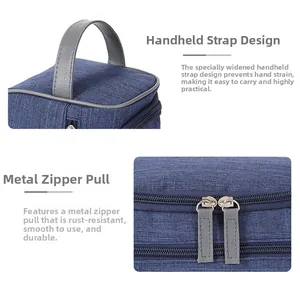 Detail of grey leather handle and smooth silver metal zipper on the navy storage bag