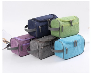 Detailed view of durable woven fabric texture and sturdy zippers on multi-color toiletry bags