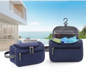 Detail view of navy blue travel toiletry bag with metal hook and breathable mesh layers