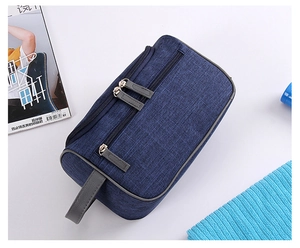 Macro shot of navy blue waterproof toiletry bag with durable fabric and double zippers