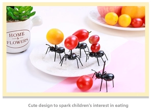 Creative black ant-shaped fruit forks used for appetizers at children's parties