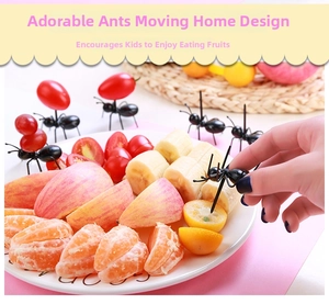 Black ant shaped fruit picks used for serving fresh fruits in a party setting