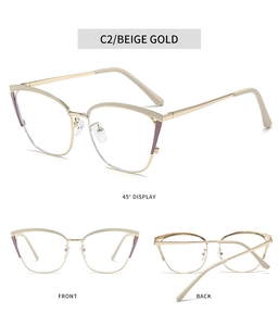 Detailed close-up of beige gold cat eye glasses frame with hollow metal side temples