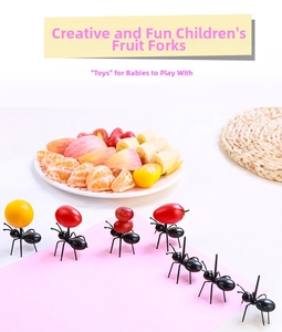 Close-up of creative ant-shaped fruit picks used for serving fresh snacks and desserts