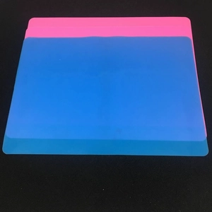 Close-up of flexible blue and pink silicone table mats with smooth rounded corners