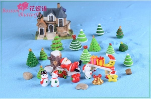 Detailed macro view of a Christmas miniature landscape set with resin ornaments on blue sand