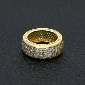 Macro detail of iced out gold plated ring with paved cubic zirconia stones on leather