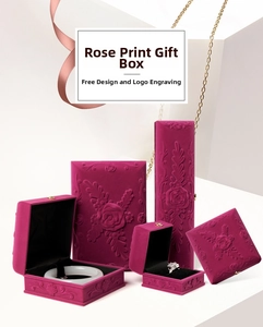 Macro shot of dark pink velvet jewelry boxes featuring elegant 3D rose relief carving details