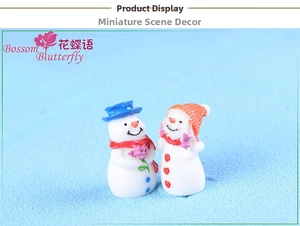 Close-up of cute snowman couple figurines with blue and orange hats for micro landscape
