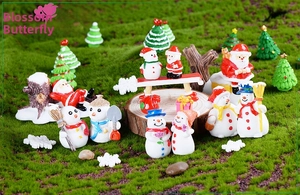 Macro view of Christmas micro landscape resin figurines with snowmen and Santa Claus