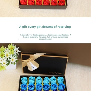 Detail of 18 red and blue soap rose petals in a black luxury gift box with ribbon