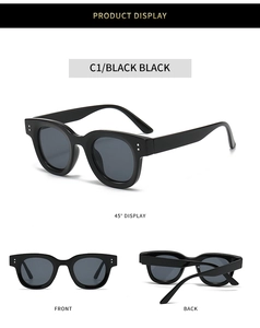 Detailansicht der schwarzen ovalen Sonnenbrille mit Silbernieten und Verlaufsgläsern