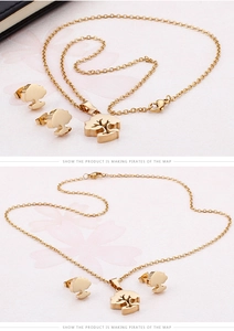 Detailed view of 18K gold-plated tree pendant necklace and matching stud earrings set