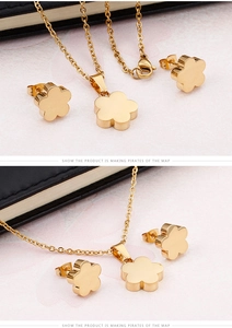 Detailed view of the gold flower jewelry set featuring simple floral studs and a necklace