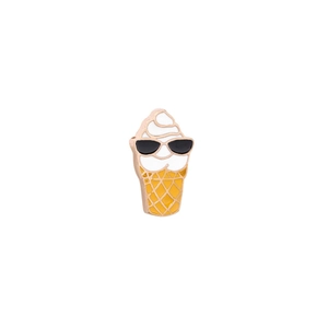 Macro shot of a cartoon ice cream enamel pin with sunglasses and golden metal edges