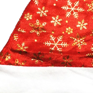 Detail of red plush fabric with golden snowflake patterns and white fuzzy trim