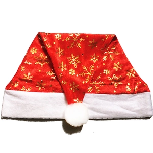 Classic red velvet Christmas hat with golden snowflakes and white plush trim for holidays