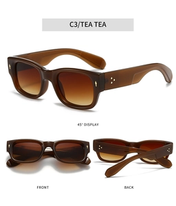 Détails de lunettes de soleil thé avec verres dégradés et accents de rivets dorés