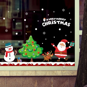 Detail of Christmas window stickers with Santa, snowman and reindeer on glass
