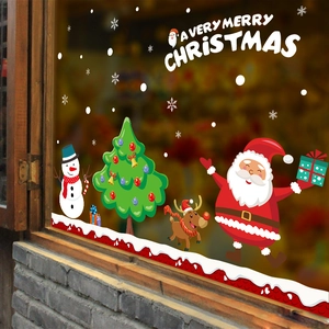 Detail view of festive Santa Claus, reindeer and snowman window stickers on glass surface