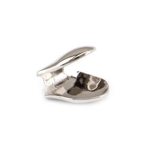 Macro view of polished silver single tooth grillz showing mirror finish and inner clip