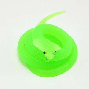 Macro detail of realistic green cobra toy made of soft translucent TPR rubber