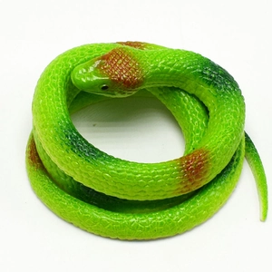 Detailed view of realistic green toy snake with brown spots and scaly texture