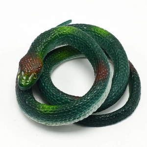Macro detail of deep green TPR cobra toy showing realistic scales and yellow eyes