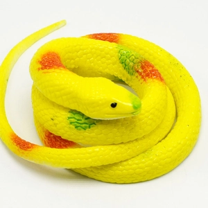Detailed view of yellow realistic rubber cobra toy with lifelike scale texture and spots