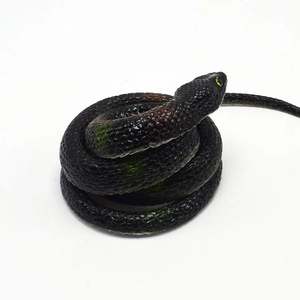 Detailed close-up of a lifelike cobra toy with realistic scales and yellow eyes