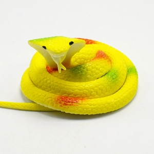 Close-up of realistic toy cobra with bright yellow scales and detailed gradient textures