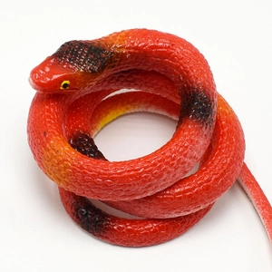 Macro shot of realistic TPR rubber cobra snake with detailed red scales and coiled body