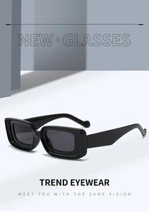 Detail view of bold black square sunglasses with wide temples and thick frame design