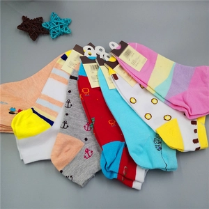 Macro view of assorted colorful ankle socks with striped and cartoon animal patterns