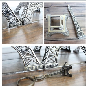 Detail of vintage metal Eiffel Tower model showing France and Paris engraving