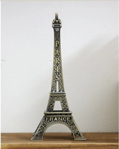Macro detail of bronze Eiffel Tower souvenir statue featuring the Paris text engraving