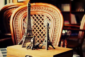 Detailed set of vintage bronze Eiffel Tower metal models and a matching keychain on display