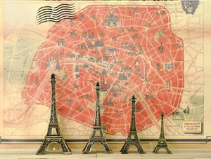 Set of four bronze Eiffel Tower figurines with vintage Paris landmark engravings