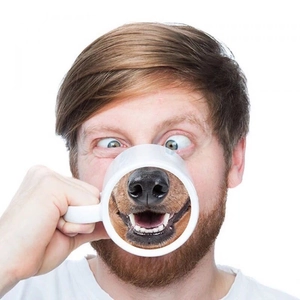 Funny white ceramic mug with dog nose bottom print creating humorous visual effect when drinking