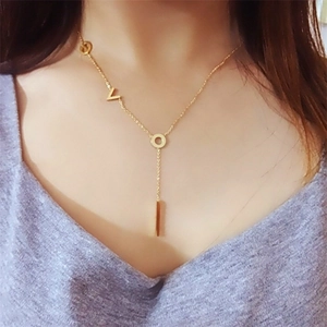 Detailed view of a gold-plated Y-shaped necklace featuring LOVE letters and a bar pendant