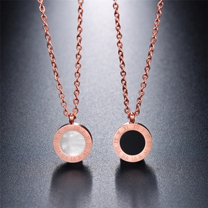 Rose gold roman numeral necklace featuring double-sided black agate and white shell inlay
