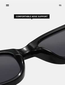 Détail du pont de nez large et intégré sur les lunettes de soleil noires épurées