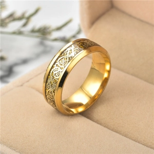 Macro view of men's gold stainless steel ring with intricate hollow dragon pattern